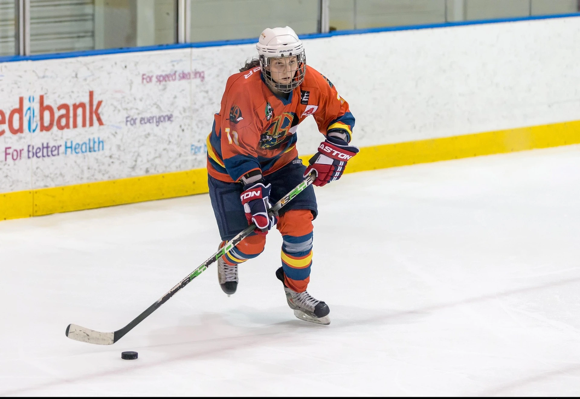 Ice-hockey-player-in-red-wearing-custom-jersey